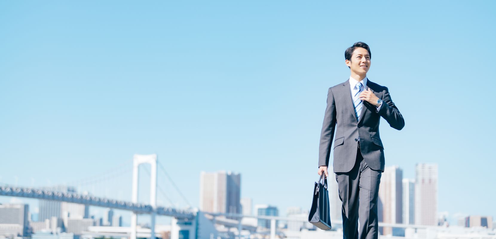 写真：レインボーブリッジを背にさっそうと前を見る若者